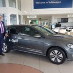 Driveline CEO Lance Manins with a VW eGolf