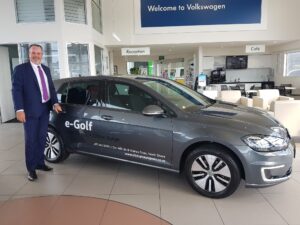 Driveline CEO Lance Manins with a VW eGolf