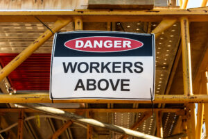 Workers above sign
